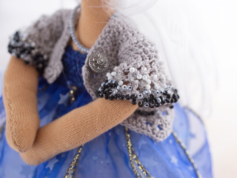 gehäkelter grauer angeschnittener Ärmel der Jacke für Lucia, an den Rändern über und über mit schwarzen, weißen und grauen Perlen bestickt